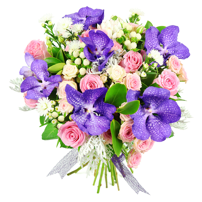 Captured against a bright white background, this hand-tied bouquet showcases a harmonious blend of exotic drama and soft romance. The focal point lies with the stunning Vanda orchids, each bloom offering an intricate tapestry of deep purples and blue-violet shades, patterned with light speckles that emphasize the graceful curvature of their petals. These orchids are carefully positioned at varying angles, drawing the eye through the design and adding a sense of movement. Surrounding them, pastel pink roses provide a gentle, soothing counterpoint. Their petals, from tightly layered buds to fully blossomed cups, create an impression of softness and familiarity. Creamy white spray roses gather in clusters around the larger roses, lending additional fullness and a subtle, cloud-like effect. Throughout the bouquet, tiny white filler flowers and clusters of white or cream hypericum berries are delicately threaded, offering fine details that reward a closer look. The foliage is a composed balance of textures: smooth, glossy dark green leaves give the arrangement its structural backbone, while feathery, silvery dusty miller adds an almost wintry coolness that sets off the warmer pink and cream tones. At the base, the stems are carefully aligned and wrapped with a sheer, shimmering ribbon in a silver-lavender hue, its delicate shine mirroring the bouquet's understated luxury. This arrangement feels perfectly suited to contemporary living spaces around Brent Cross, from stylish apartments near the shopping centre to family homes stretching towards Cricklewood and Hendon. Whether chosen for Valentine's Day, a wedding anniversary, or a meaningful congratulations, it reflects the practiced hand of a local florist who understands both modern style and the enduring appeal of classic blooms.