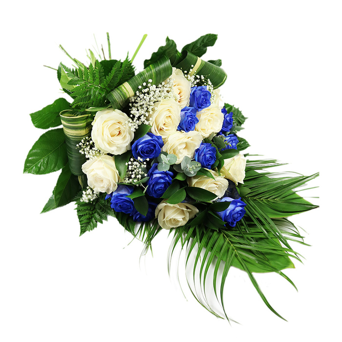 A luxurious funeral spray in blue and white unfolds across a stark white background, its form widening at the top and narrowing gracefully into a cascading point. At the centre, a plentiful collection of roses-around two dozen in number-creates a sumptuous display of texture and colour. Intense sapphire blue roses sit alongside creamy white and ivory blooms, each rose fully open so that its velvety petals spiral outward in generous layers. The blue and white flowers are carefully interspersed, forming an even, harmonious pattern that feels both contemporary and reverent, a combination often seen in sympathy arrangements delivered across Brent Cross and the surrounding residential streets. Between the larger rose heads, the florist has woven in delicate tufts of white baby's breath, their tiny blossoms forming a fine, starry mist that softens and connects the bolder flowers. Lush greenery frames this floral heart. Broad, dark green leaves provide a polished, structural foundation, their surfaces gleaming subtly under the light. From the upper left, feathery bright green ferns fan outward, adding airy texture and a sense of gentle lift. From the lower right, long, slender palm fronds arc downwards, emphasising the teardrop cascade and creating a natural sense of motion and flow. Small sprigs of bluish-green eucalyptus-like foliage are tucked throughout, their muted tone and rounded leaves adding cool contrast and visual depth. Wide, striped green-and-cream leaves, folded into neat horizontal bands and soft coils, punctuate the greenery with a tailored, designer touch. The lighting in the image is clear and even, bringing out every curve of petal and every vein in the leaves. Overall, the spray radiates calm dignity and quiet solace, a considered tribute well suited to memorial services, chapels, or graveside farewells around Brent Cross.
