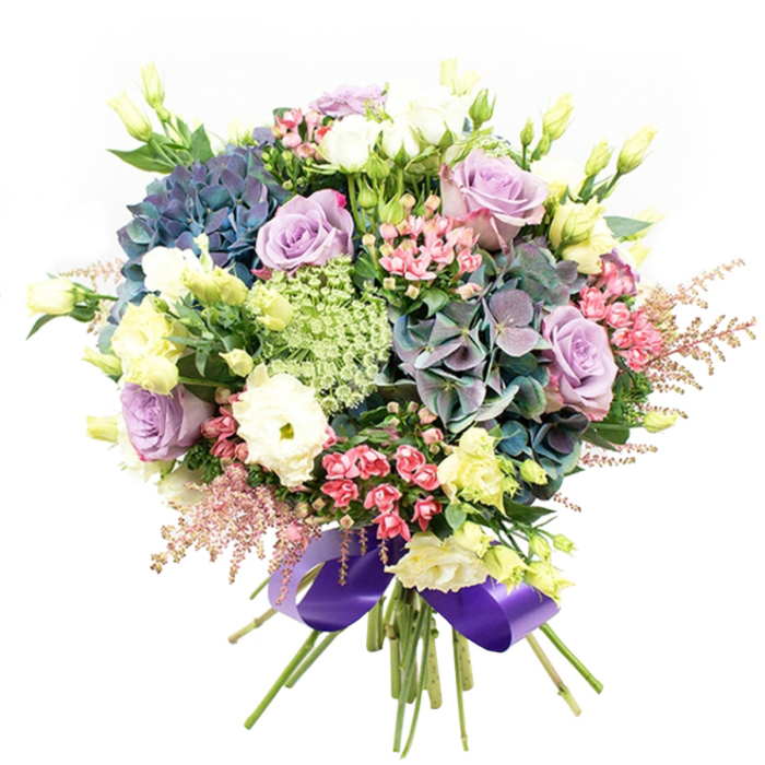 A celebration of colour harmony and texture, this lavish bouquet-crafted by a seasoned Brent Cross florist-showcases a beautifully orchestrated collection of fresh blooms, instinctively arranged against a crisp white background that evokes the clarity of early morning light along Claremont Road. Heartfelt clusters of voluminous hydrangeas in velvet indigo, teal, and soft muted purple form the opulent backbone of the arrangement. Complementary roses in softest lavender and creamy white offer romantic sophistication, while plush white ranunculus with many-layered petals convey classic, timeless beauty. Feather-like astilbe plumes in blush pink and dainty pink filler flowers bring soft dimension and a touch of wildflower spontaneity, ensuring the bouquet shimmers with gentle playfulness. Tall, slender stems of chartreuse eustoma buds reach upward, contributing an airy, youthful energy. Intricate, lacy green-and-white filler blooms highlight the central cluster, enhancing the overall depth. Green foliage is artfully placed to provide grounding contrast, amplifying the brilliance of the featured florals. Carefully tied with a broad, glossy royal purple satin ribbon, the bouquet exudes elegance and is ready to be delivered with care to homes and businesses around Brent Cross and Hendon. An ideal choice for gifting, celebrations, or simply elevating a special table with the inviting luxury of local floral design.