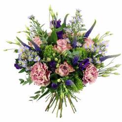 Against a clean, white background, this elegant bouquet appears as a rounded, full-bodied arrangement of pastel and jewel tones, crafted with the precision of an experienced Brent Cross florist. Soft pink roses are the first flowers you notice, some tightly furled and others more fully opened, their velvety petals spiralling outward from richer rose-pink centers to paler, almost ivory-tinted edges. Interspersed closely with them are lush carnations in dusty rose and mauve, with densely packed, frilled petals that introduce movement and texture, giving the bouquet a tactile, almost cloud-like quality. Piercing upward from this gentle base are slender spikes of deep lavender and indigo Veronica, adding height and rhythm and drawing the eye in the same way the elevated roads around Brent Cross catch the skyline. Nestled between the vertical accents are clusters of rich purple lisianthus and light, feathery sprays of aster-like blooms in soft lavender-blue, each tiny daisy-like head finished with a cheerful yellow center. The flower heads are framed by an abundant mix of greenery: bright lime-green filler flowers and chartreuse tufts contrast vividly with cool eucalyptus leaves and other foliage ranging from silvery sage to deep forest green. The stems at the bottom are gathered neatly into a classic hand-tied bundle, suggesting the arrangement is ready to place straight into a vase on a dining table in a home near Cricklewood, Temple Fortune, or around Brent Cross itself. The overall mood is one of refined celebration and gentle warmth, ideal for marking a birthday, anniversary, or heartfelt thank-you with a same-day bouquet delivery in this part of North West London.