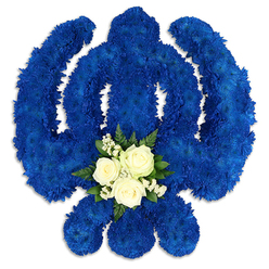 This image shows a beautifully executed Sikh Khanda floral tribute, presented against a pure white background so that every detail of the design feels clear and intentional. The full shape of the emblem-the upright central sword, framed by the unbroken ring of the chakkar and flanked by two gently curving kirpans-is sculpted from densely packed royal blue chrysanthemum blooms or similar small flowers. Their tightly layered petals create a velvety, almost cushion-like surface, with slight variations in tone where the light brushes across the blue, suggesting both softness and strength. At the lower centre of the symbol, nestled into the blue, is a calm, luminous cluster of white flowers. Three white roses, perfectly shaped and just beginning to open, form the centrepiece, surrounded by tiny stars of baby's breath and supported by deep green foliage, possibly fern or salal. This small spray introduces a quiet contrast, echoing themes of purity, remembrance, and serenity at the heart of devotion. The overall effect is one of composed elegance, as though the tribute has been carefully arranged on a stand for a funeral or memorial service. The white background and delicate shadowing give the arrangement a sense of presence, almost as if you could reach out and feel the cool petals. Created with thought and care by a florist familiar with the Brent Cross community and nearby areas like Cricklewood and Finchley, this Khanda tribute offers a meaningful, visually powerful expression of sympathy, especially suited to Sikh remembrance ceremonies and farewell gatherings.