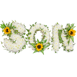 This sympathy piece spells SON in bold, sculpted capitals, each letter composed of hundreds of tight, snowy white chrysanthemums packed to create a plush, tactile surface that appears almost cloudlike. As an experienced Brent Cross florist I picture this arrangement catching the soft morning light before delivery - the chrysanthemums' subtle tea-like scent and velvety texture calming to the senses. Dark green ivy trails are woven through every letter, their trailing tendrils and shiny leaves suggesting continuity and remembrance, while fern fronds and assorted greenery tuck in around the edges to shape the letters and give them gentle relief. Three cheerful sunflowers punctuate the design with bright, sunflower-yellow petals and unmistakable dark brown centers: one nestling into the upper left curve of the S, another resting low in the O's interior, and a third accenting the upper right of the N. Those sunflowers lend warmth and the suggestion of light breaking through sorrow, a deliberate contrast to the white chrysanthemums' quiet dignity. The whole tribute is photographed on a stark white backdrop so that textures, shadows, and the precise placement of ivy and petals are easy to read visually and by description. Thoughtfully suited to funeral chapels, memorial services near Brent Cross Shopping Centre or family homes in Hendon and Cricklewood, this composition is both a personal keepsake and a public gesture of love, crafted to balance solemn respect with an uplifting sense of remembrance.