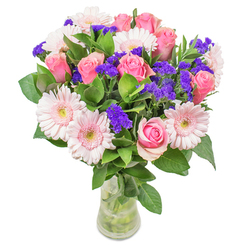 As these flowers come together in the heart of Brent Cross, the arrangement captures a radiant interplay of colour and form. Delicate gerberas in gentle blush tones exude airy innocence, balanced by classic pink roses whose petals spiral open with quiet confidence. Deep purple statice nestles between, offering visual punctuation and a subtle, papery fragrance-the bouquet's signature accent. The fresh green foliage creates a lush, abundant base, as if gathered from the shaded gardens scattered throughout nearby neighbourhoods. Displayed in an understated, slender glass vase, the bouquet glimmers softly in natural light, accentuating the pastel hues and dynamic shapes. It is an ensemble that feels at once uplifting and sophisticated, much like a spring morning strolling along Brent Cross's leafy avenues. Designed by experienced local hands, this bouquet is perfect for bringing comfort to a friend recuperating at home or adding vibrant artistry to a modern flat-always with the mark of Brent Cross Flowers' care and creativity.