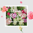 At the centre of the scene, a sumptuous bouquet of roses unfolds like a promise carried across twelve months of thoughtful flower deliveries. The roses, arranged in a generous, rounded shape, range from the softest blush and pastel pinks to creamy whites, gentle lilacs, and deeper raspberry and fuchsia tones, creating a nuanced, romantic palette. Each bloom is rich with layered, velvety petals, some fully open with broad, cupped faces, others still half-closed, hinting at beauty yet to come. Fresh green leaves weave throughout the arrangement, their glossy texture and rich colour providing a vibrant frame that echoes the greenery of nearby Brent Cross parks and gardens. Around the central cluster, rose petals and a few small blossoms appear to float against a pale background, like confetti gently suspended in midair, reinforcing the feeling of celebration and continuity. The lighting caresses the petals, bringing out subtle highlights and shadows that give the bouquet depth and dimension, as if you could reach out from a dining table in a Brent Cross flat and feel the cool, silky touch of each flower. Though the image is still, it hints at a cycle of deliveries, each bouquet arriving at doors near Hendon, Dollis Hill, or along the North Circular, filling homes with a luxuriously soft, sweet fragrance. More than a single gift, the composition evokes an ongoing conversation of care, with every new arrangement offering a fresh chapter of colour and comfort throughout the changing seasons in this corner of North West London.