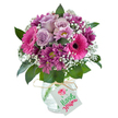 Brimming with charm and colour, this bouquet conveys the heart of Brent Cross through a lively blend of pink and purple hues. Soft, pale lavender roses form the tender inner circle, their petals gently open and invoking a freshness akin to springtime near Brent Reservoir. Encircling them are vibrant fuchsia Gerbera daisies, their daisy-like forms rich in both hue and texture, punctuated by dark, captivating centers. Nestled alongside are clusters of deep magenta and plum-toned chrysanthemum-lookalikes, their yellow-green centers adding depth and vitality. Sprigs of airy, cloud-white baby's breath intersperse the composition, giving a floating, celebratory quality. Glossy, dark green leaves ground the bouquet, recalling the nurturing green spaces of Brent Cross's parks. The flowers are arranged in a rounded clear glass vase with a crackle-ice finish, simply yet elegantly fastened at the neck with a rustic raffia tie. Dangling from the ribbon is a blank white rectangular gift tag-perfect for a personal greeting to mark birthdays, anniversaries, or to send a spontaneous burst of joy to friends near Brent Cross Shopping Centre or surrounding neighbourhoods. This bouquet, designed with a local touch, is ready for quick delivery throughout the area, offering a thoughtful expression of beauty and care.