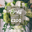 Stunning in white and lime, this Florist Choice bouquet embodies luxury and precision. Tall white lilies rise with architectural grace, their petals unfurling to catch the day's light and cast a soft scent through the frame. They are paired with generous splashes of lime-green texture-Green Trick dianthus or lime hydrangea heads-setting a bright, modern counterpoint to the pristine whites. Smaller white blooms-ranunculus or spray roses-fill the middle spaces, adding density and a plush, velvety feel. Dark green foliage threads through the arrangement, a lush support that anchors the composition and adds depth. The bouquet is hand-tied, the stems clean and firm, and it is being held by a person, their light dress blurred in the upper left, suggesting a wedding or celebratory event in Brent Cross. The image centers on a crisp white frame containing the brand's mark: Florist Choice at the top in elegant script, BOUQUET in uppercase below, and a bold £200 at the base. The image signals a premium flower gift, carefully designed for high-end occasions and available for same-day delivery to Brent Cross, Cricklewood, and Golders Green, reflecting Brent Cross Flowers' commitment to freshness, craftsmanship, and local service.