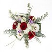 This bouquet, seen from above, is a luminous expression of harmony and local artistry, echoing the sense of community that fills Brent Cross. Red roses, velvet-soft and tightly petaled, create a vivid centerpiece that feels both timeless and heartfelt. Around them, snowy white gerberas and clusters of dainty chrysanthemums exude a calming radiance, their petals glowing just as warmly as a sunny afternoon on Brent Cross's quiet lanes. Sprigs of eucalyptus, pale and gently curved, stretch gracefully outward, adding a modern twist and a breath of invigorating, grassy scent. In between, lilac lisianthus twine delicately, infusing the design with an unexpected softness and cool elegance. Every flower and leaf is arranged with loving intention, their natural forms celebrated yet carefully balanced-a nod to the expertise of North London florists. The composition feels festive, comforting, and refined, making it a favorite for heartfelt anniversaries, family reunions, or a sophisticated centerpiece. Each element shines beneath gentle, natural light, capturing the unique spirit and warmth of Brent Cross in floral form.