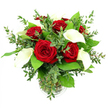 This photograph shows a refined bouquet of red roses and white calla lilies arranged in a clear glass vase, set before a pure white background that underscores the bouquet's modern, luxurious feel. At the core of the design are several large red roses, about six or seven blooms, each one fully opened and showing off layers of velvety petals in a deep, saturated crimson that seems to glow against the clean backdrop. Woven among them, four or five white calla lilies rise with sculptural grace, their smooth, funnel-shaped spathes sweeping upward and outward, revealing slim yellow spadices like delicate candles. The surrounding greenery gives the arrangement both volume and softness: sprigs of eucalyptus with small, rounded leaves in a cool silvery-green tone are interlaced throughout, adding a feathery, slightly cascading effect, while broader emerald green leaves form a polished base that cradles the main blooms. The slender stems are gathered neatly and visible through the cylindrical glass vase, which is partially filled with clear water and finished with a subtle ribbed feature near its base. Bright, even lighting spreads over the flowers, heightening the contrast between red, white, and green and drawing out the different textures-from the plush rose petals to the glossy foliage and sleek lilies. The overall mood is romantic yet composed, ideal for sending a heartfelt message around Brent Cross, whether it's a same-day delivery to a home near Brent Cross station, a thoughtful centerpiece for a dinner party in Hendon, or a significant gesture for a loved one staying at a hotel close to the shopping centre.