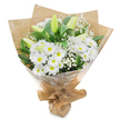 This understated yet elegant bouquet is photographed upright against a pristine white background, giving the impression that it is suspended in calm, clear space. The arrangement is dominated by clusters of white chrysanthemum-style daisies, their narrow petals layered in neat circles that form plush, rounded heads. Each blossom features a distinct yellow-green centre, which adds a gentle hint of colour and liveliness without disturbing the overall serenity of the design. Together, these daisies create a softly textured surface that feels warm and reassuring, like a quiet presence in a room. Punctuating this base, several tall, closed lily buds rise above the other flowers, their slender, elongated shapes clothed in smooth pale green that gradually softens into ivory at the tips. They provide vertical rhythm and a sense of restrained sophistication, suggesting future blossoms that will open in their own time. Wispy strands of white baby's breath are threaded throughout, their tiny blooms scattered along fine, branching stems, creating a veil of lightness that gives the bouquet a gentle, airy halo. Encasing the flowers, lush dark green foliage fans out, its broad, glossy leaves enhancing the whiteness of the petals and adding a natural depth to the composition. The stems are firmly gathered at the base and cloaked in rustic brown kraft paper, folded into a clean conical shape whose crinkled texture conveys the care of a florist's hands. Over this, a clear cellophane wrap adds a subtle sheen and keeps the bouquet secure, as though freshly prepared for same-day delivery from a local Brent Cross florist to a home in nearby Finchley or along the North Circular. The mood is peaceful and contemplative, making this design particularly suited for sympathy messages, remembrance services, or offering quiet support in times of loss.
