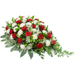 A graceful red and white casket spray is presented against a clean white background, where its shape and colours can be fully appreciated without distraction. The arrangement runs from left to right in a gentle, elongated curve, fuller on the left side and narrowing to a refined, trailing point on the right, like a slender crescent made of flowers. Deep red roses are scattered throughout the design, each bloom rich and velvety, petals spiralling inward to suggest depth of feeling and a love that lingers. Interspersed with them are many white carnations, their ruffled petals forming soft, rounded mounds that contrast tenderly with the intensity of the roses. The combination of crimson and white reads as both dignified and comforting, a traditional choice for moments of remembrance. All of the flowers are supported by an abundant layer of greenery. Broad, dark green leaves form the main structure, giving the spray a substantial, grounded base, while elegant sprigs of silvery-green eucalyptus add a misty, cool-toned accent that runs through the arrangement like gentle shadows. Toward the right-hand tip, lighter green, trailing stems extend outward, creating a delicate cascade that softens the outline and adds a sense of gentle movement, as though the piece were shaped by a passing breeze. This is the kind of tribute you might see at a quiet funeral service in Brent Cross or nearby Hendon, thoughtfully arranged to rest on a casket or memorial table. One can almost imagine it arriving fresh that morning, the scent of roses and foliage filling a chapel and offering a silent, heartfelt message of respect and farewell.
