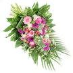 A beautifully composed funeral spray is photographed on a plain white background, drifting in a diagonal line from the upper left to the lower right with an easy, natural grace that feels at home in Brent Cross's quieter residential streets. The arrangement is lavish yet carefully balanced, combining pastel pink, deep fuchsia, rich purple, and bright white blooms with layers of textured greenery. Prominent among the flowers are generous gerbera daisies, some in gentle blush tones and others in more intense magenta shades, their open, daisy-like faces adding a sense of youthful brightness. Woven around them are classic pink roses, each bloom tightly nested with spiralling petals that symbolise devotion and love that endures. Soft white flowers, likely small carnations or chrysanthemums, tuck into the spaces between, adding plush, ruffled contrast, while sprays of delicate white daisy-style blossoms lend an airy, meadow-like feel. Here and there, clusters of red hypericum berries peek through, their polished red surfaces creating small accents of warmth and interest. The foliage forms a rich backdrop: broad, glossy dark green leaves give strength and depth; fine fern fronds bring a light, feathery movement; and rounded, silvery eucalyptus leaves soften the palette with cool grey-green tones and a gentle, refreshing scent. From the lower right corner, long, slim palm leaves trail outward, accentuating the cascading design and guiding the eye along the spray's flowing line. At the upper left, the neatly bound stems are visible, hinting at the careful handwork involved. Crafted as a casket spray or large memorial tribute for services around Brent Cross and nearby North West London venues, this piece offers a tender, peaceful expression of sympathy and remembrance.