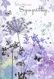 This card unfolds like a soft, visual elegy, its colours and lines as calming as the soft evening sky above Brent Cross after a long day. Dominating the design are slender wildflower silhouettes, particularly umbelliferous shapes whose fine stems stretch skyward before opening into rounded heads formed from dozens of tiny, star-like florets. These floral forms are drawn in graceful shades of lavender, indigo, and gentle blue, resting against a backdrop washed in muted violet and cool, silvery green that flows across the page in translucent layers. The flowers have an airy, weightless quality, as if they're lightly swaying in a distant meadow touched by a gentle breeze. Between them, faint shadows and impressions of additional foliage appear like soft echoes, adding depth and a sense of quiet distance. Floating among the blooms, butterflies hover with delicately suggested wings, their outlines just visible, hinting at motion without disturbing the stillness. They evoke themes of transformation, tender presence, and the way memories seem to hover close to us, especially in times of grief. The light across the illustration is diffused and forgiving, smoothing edges and letting no single feature dominate. The tone feels contemplative, respectful, and deeply gentle-an image that offers room for silence and reflection. When we at Brent Cross Flowers match a card like this with a sympathy bouquet or funeral arrangement for a local family, it becomes more than just paper and ink; it's a quiet companion, carrying a message of sincere sympathy and the reassurance that someone has taken the time to choose something soft, beautiful, and truly thoughtful.